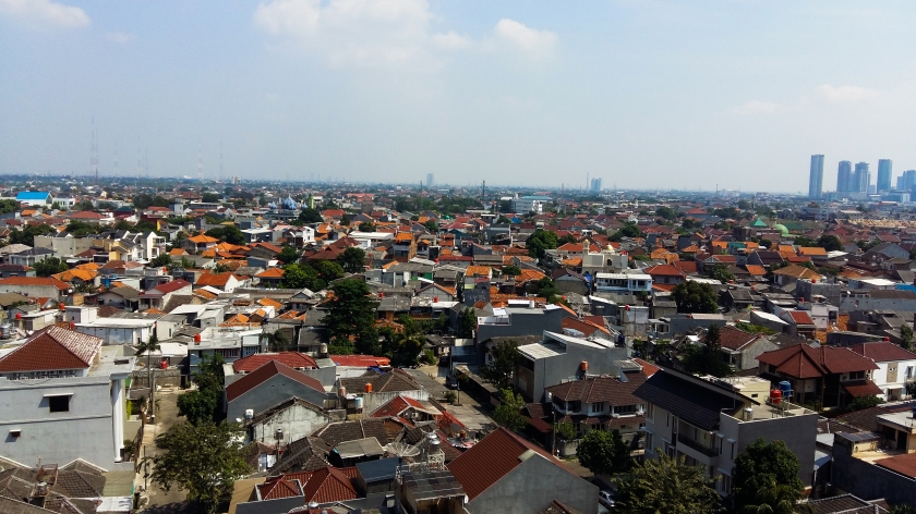 View over the multi-coloured rooftops of homes and businesses in West Jakarta.